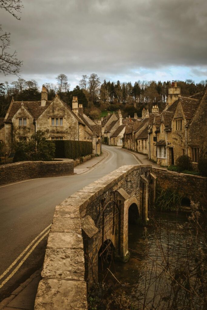 Quiet Cotswolds village lane with honey-stone cottages and a romantic feel