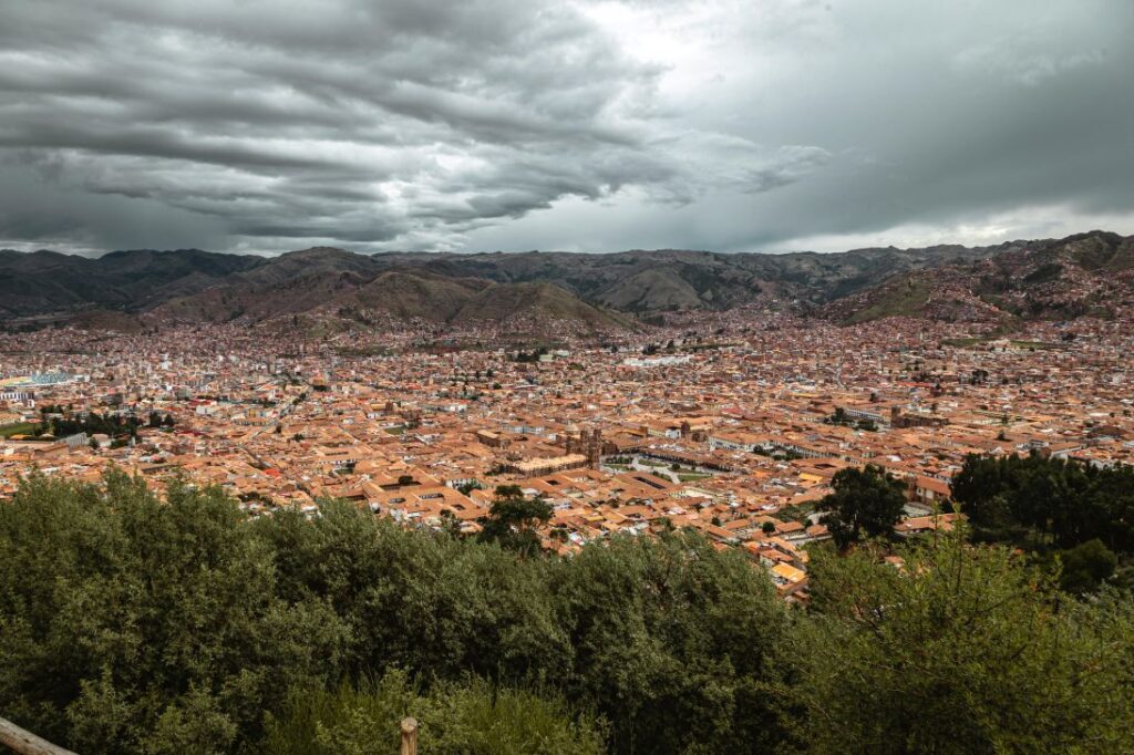 Couple enjoying rooftop pisco hour above Cusco Plaza de Armas