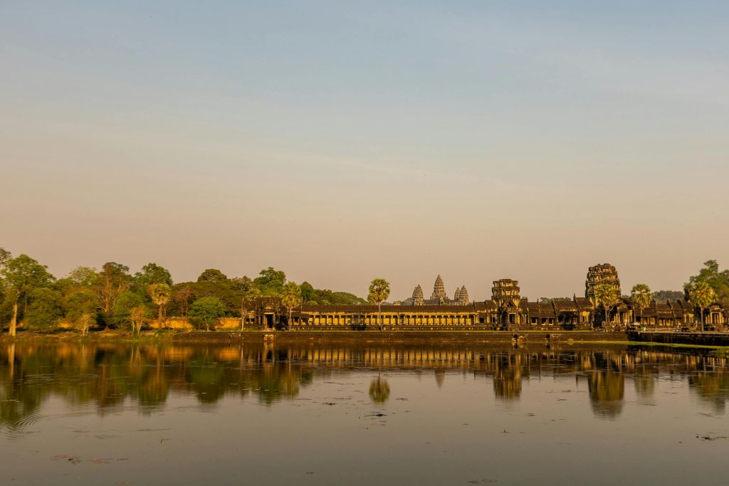 Couple walking toward Angkor Wat at sunrise during a luxury Cambodia trip