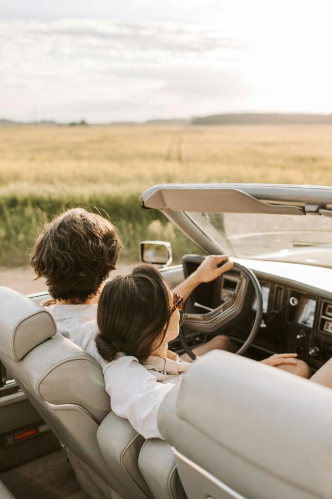Couple enjoying a scenic luxury road trip through the Cotswolds countryside