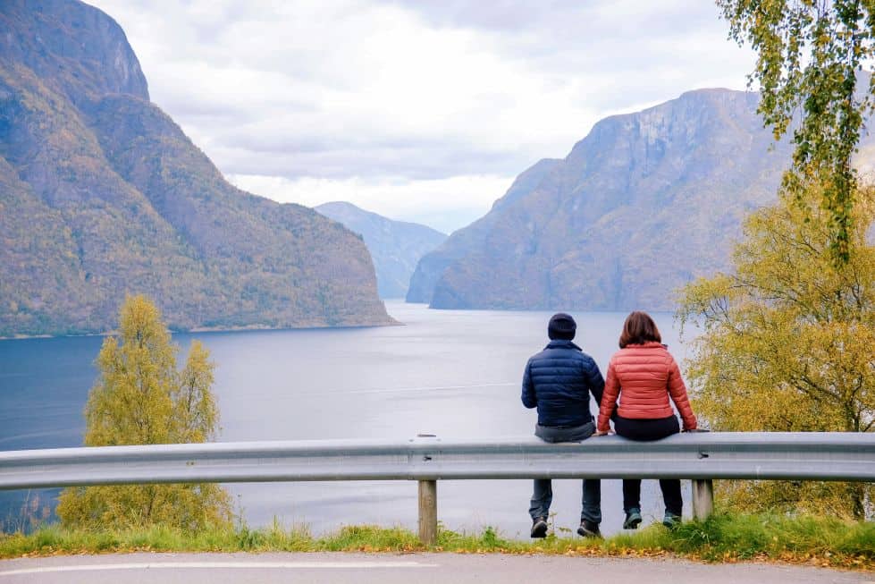Couple overlooking the Norwegian fjords during a scenic romantic getaway