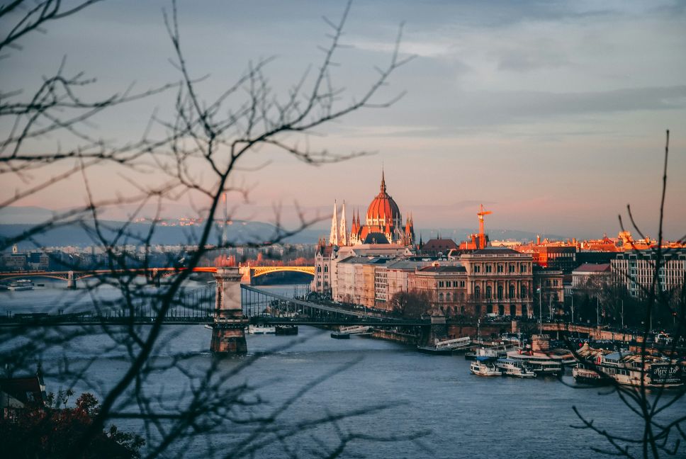 Budapest Parliament and the Danube River at dusk.