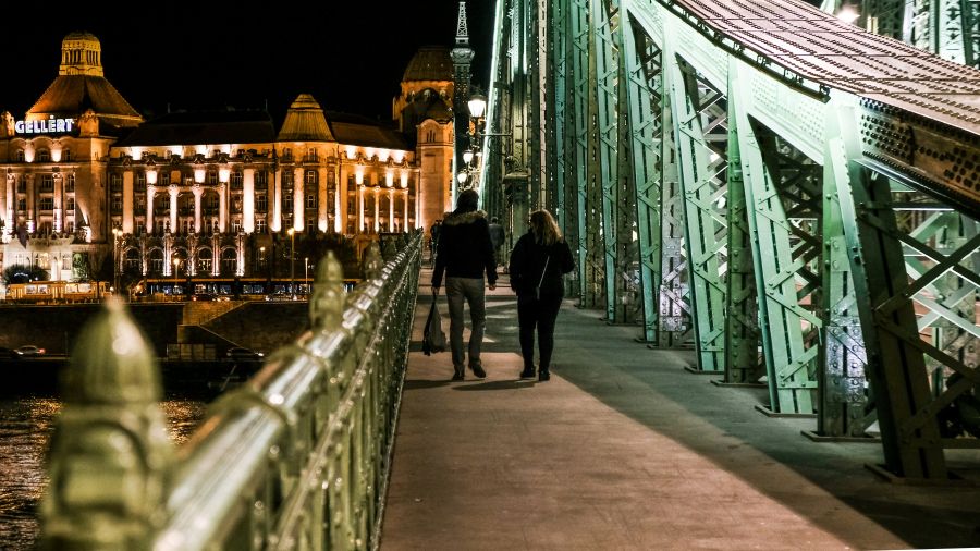 Couple walking along the Danube after a Budapest dinner.
