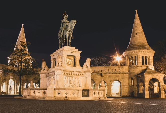 A couple enjoying panoramic nighttime views of Budapest from Fisherman's Bastion