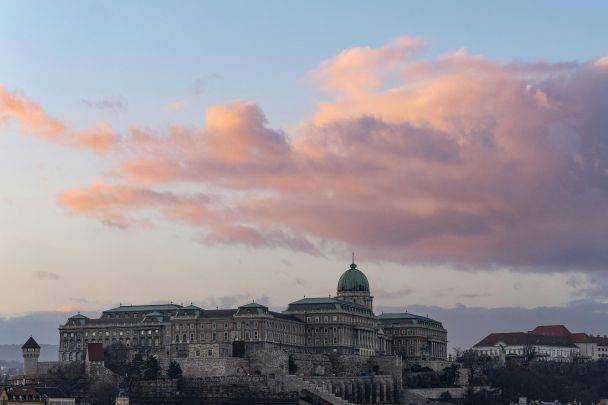 A candlelit dinner table with views of Budapest illuminated at night