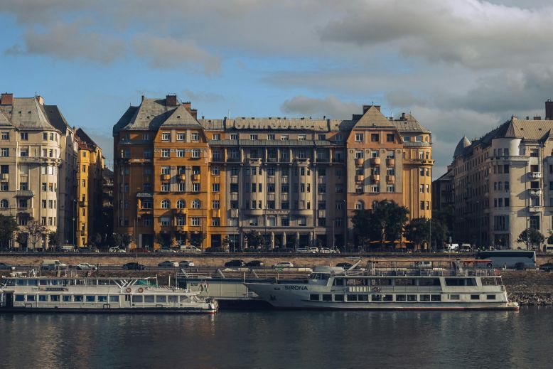Luxury hotel balcony overlooking the Danube River and Hungarian Parliament Building.