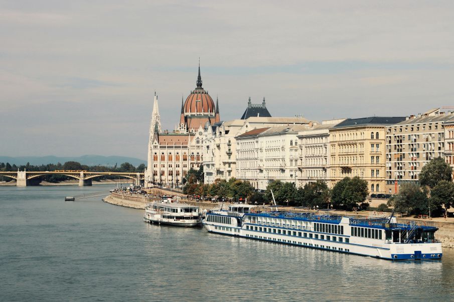Luxury travelers planning their Budapest itinerary inside an upscale hotel lounge.