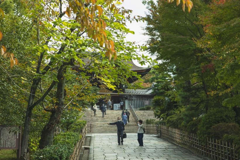 Couple walking through a quiet Kyoto temple garden