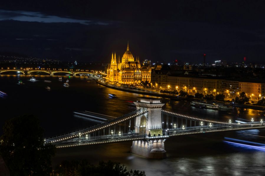 An evening river cruise sailing past Budapest's illuminated waterfront