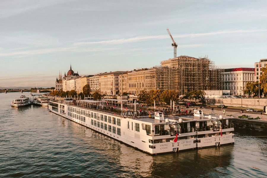 [Empty nester couple reviewing Danube river cruise costs before booking]