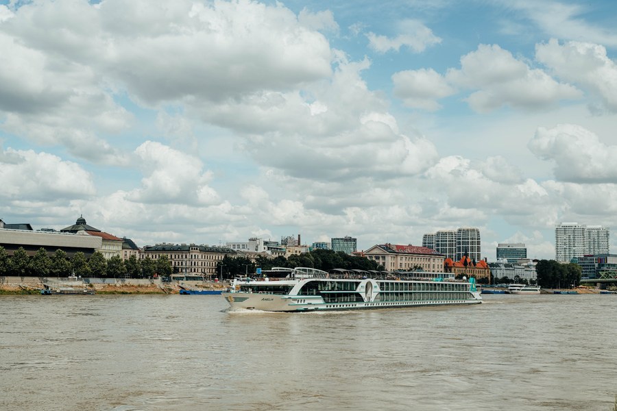 [Couple comparing Danube river cruise prices while planning a luxury European river cruise]