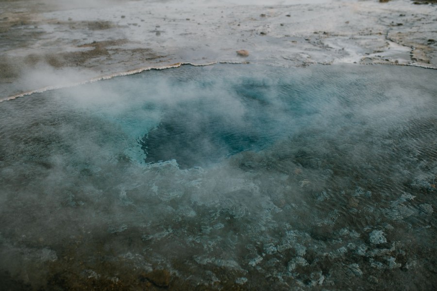 Couple relaxing together in a steaming Iceland geothermal lagoon.