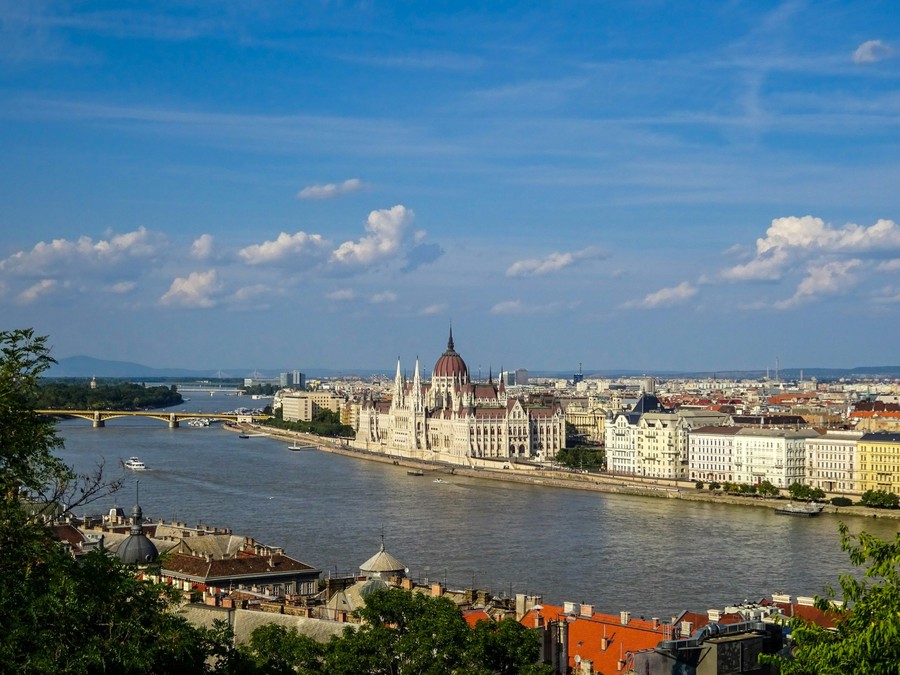 Viking-style river cruise ship docked near a historic European city