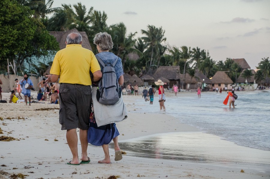 Empty nester couple reviewing a travel itinerary during a relaxed food and wine vacation.